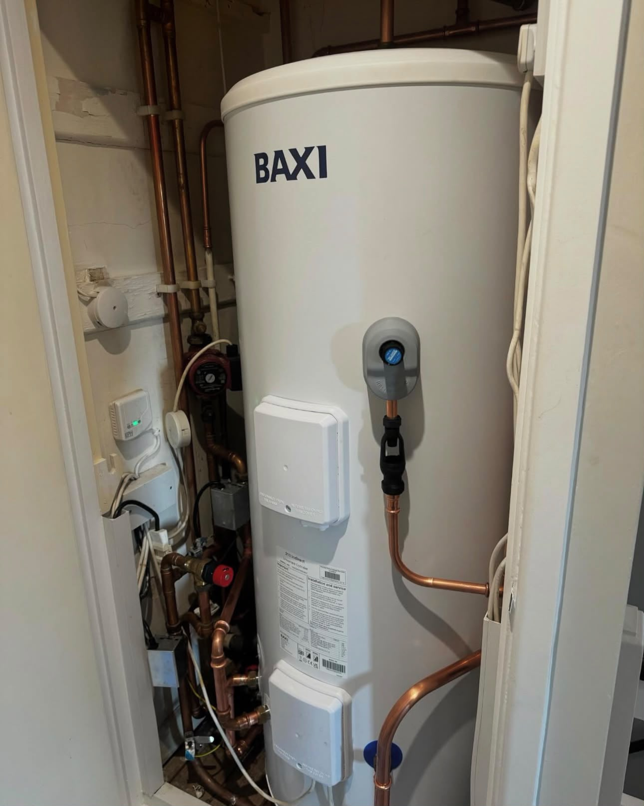 Baxi unvented hot water cylinder fitted in a compact airing cupboard with copper pipework