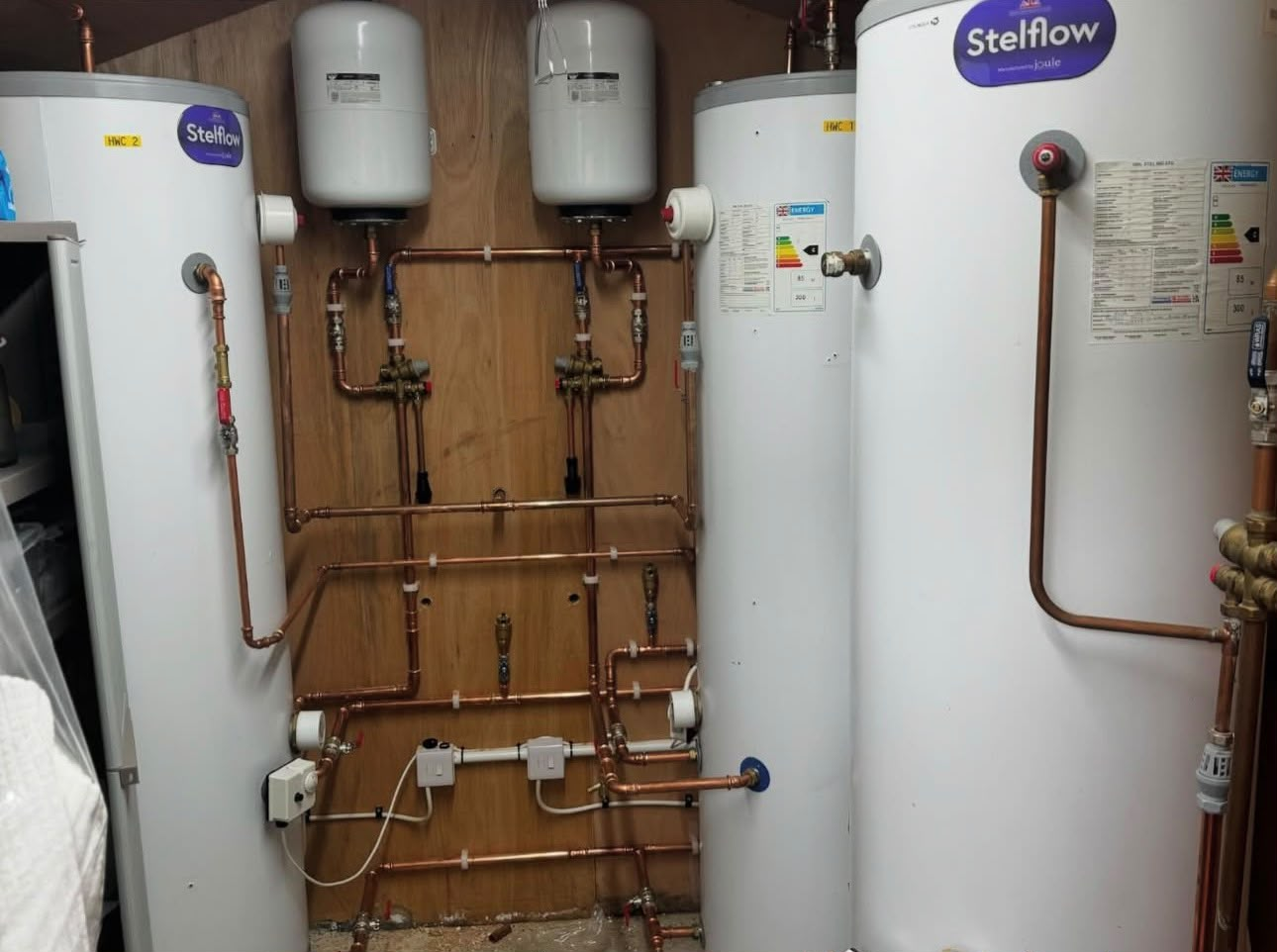 Multiple Stelrad hot water cylinders installed with expansion vessels and tidy copper distribution pipework